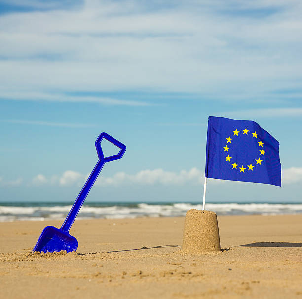 istock European communities flag on a beach with blue spade 490014780