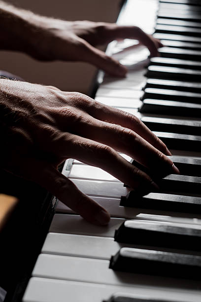 istock Close up of two hands playing music 490019142