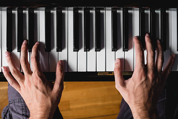 istock Pov of two hands playng piano 490019622