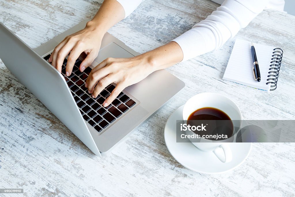 Working in the computer Working in the computer and drinking a coffee 2015 Stock Photo