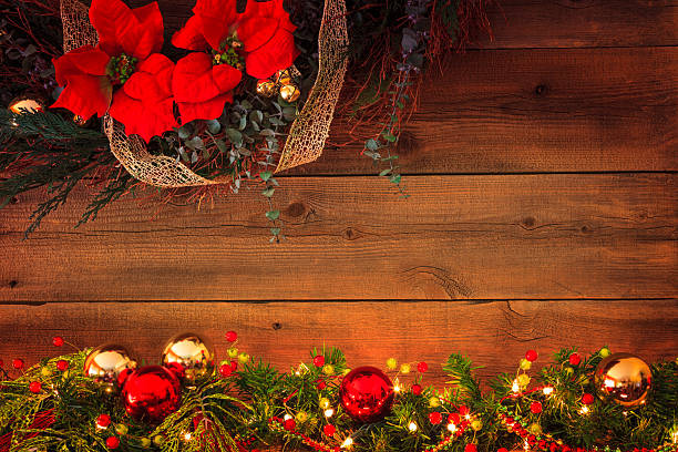 A Christmas Garland with ornaments and lights fill the foreground leading to a rustic wooden backgroundhttp://i1136.photobucket.com/albums/n486/Ron_Patty/Christmas_zps36a79558.jpg
