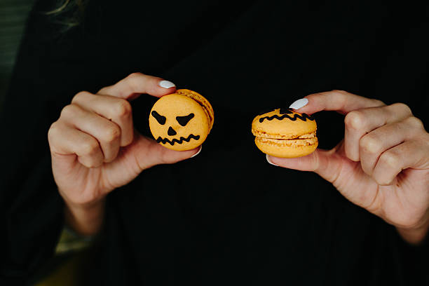 istock woman holding a biscuit for Halloween 490021182