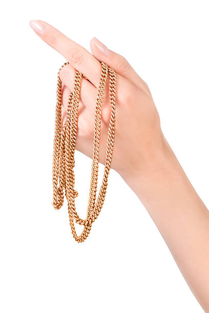 istock female hand with golden chain 490021576