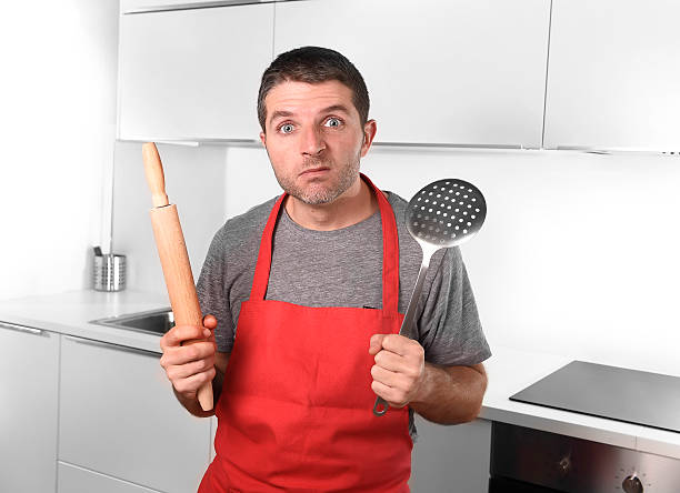 istock home cook holding skimmer and rolling pin wearing  apron 490021892
