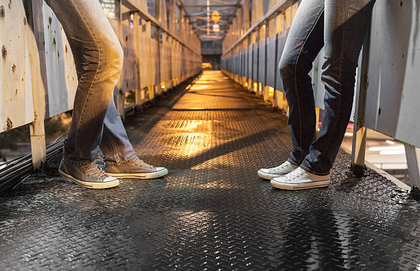 istock male and female relaxing on a bridge 490021896