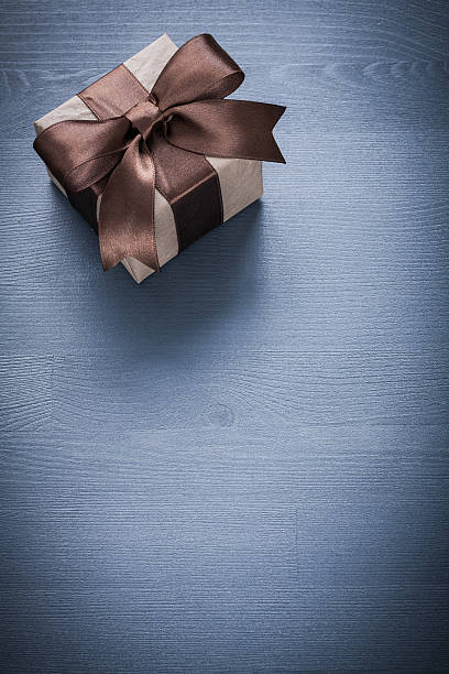 istock Gift box on vintage wooden board holiday concept 490023300