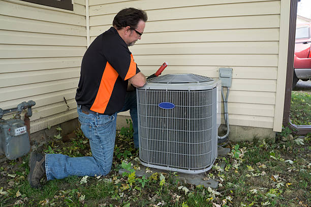 istock Repairman Checking Outside Air Conditioning Unit For Voltage 490023714