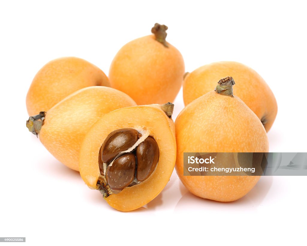 Close up view of some loquat fruit Close up view of some loquat fruit isolated on a white background 2015 Stock Photo