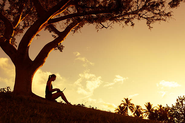 istock Woman reading in the park 490027266