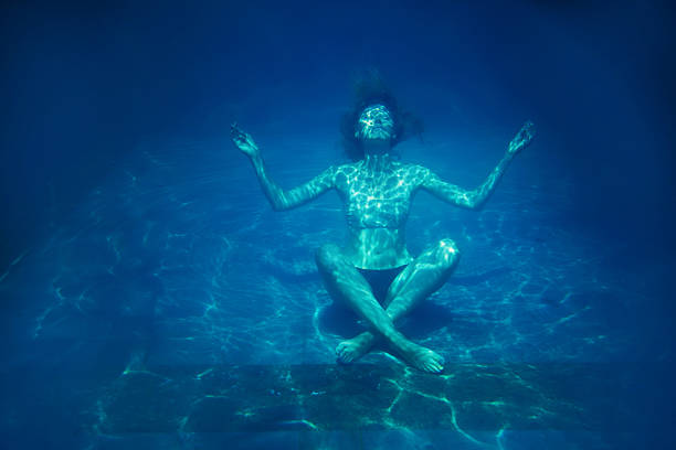 mulher sentada sobre o fundo de piscina com lotos pose - swimming pool water people sitting imagens e fotografias de stock