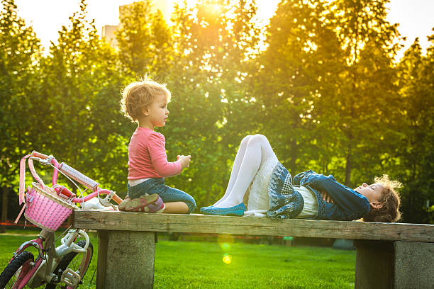 istock Funny little children sitting on bench 490043332
