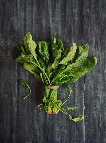 English spinach bunch on wooden background