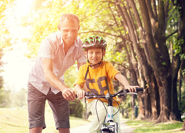 istock Father learn his son to ride bicykle 490048524