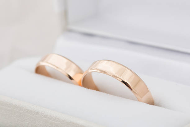istock Golden engagement rings in a white box 490051182