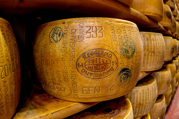 Parmagiano Reggiano cheese aging Parmigiano-Reggiano or Parmesan cheese, is a hard, granular cheese made in Italy.  parmesan stock pictures, royalty-free photos & images