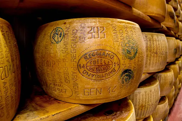 Parmigiano-Reggiano or Parmesan cheese, is a hard, granular cheese made in Italy. 