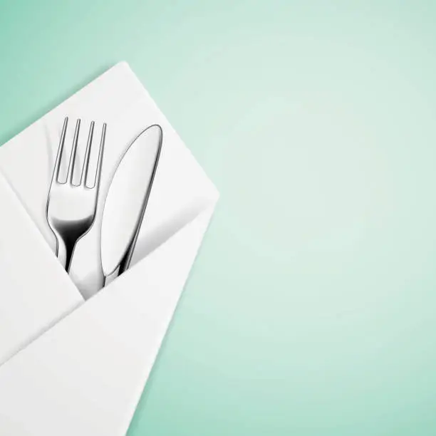 Vector illustration of Fork and knife in a napkin.