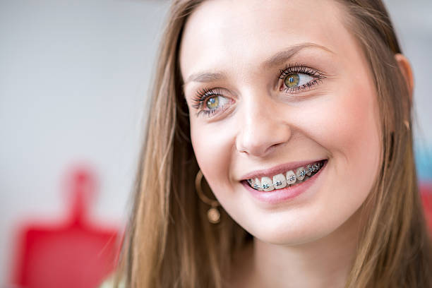istock Smiling young woman with braces 490055490
