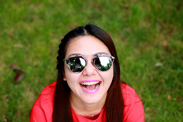 istock young woman looking at camera with sunglasses 490057748