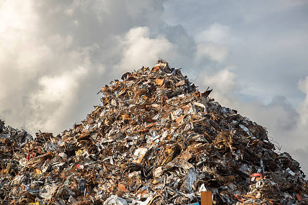 heap of scrap iron heap of scrap iron against dramatic cloudy sky junkyard photos stock pictures, royalty-free photos & images