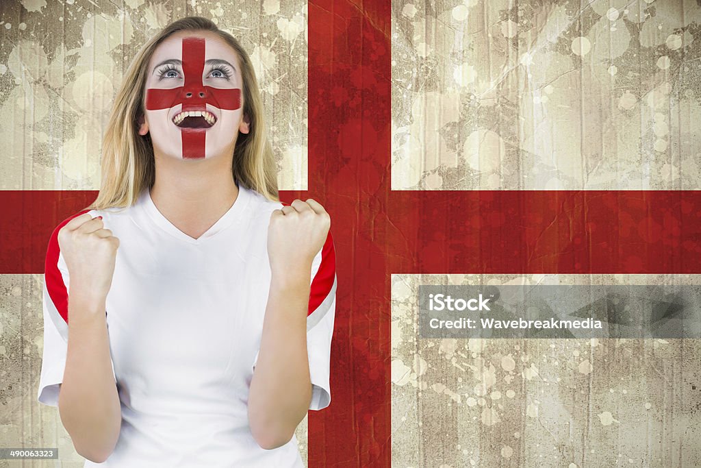 Excited fan england in face paint cheering Excited fan england in face paint cheering against england flag in grunge effect Soccer Stock Photo