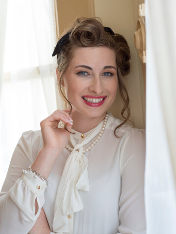Young woman in 1940's style clothes, hair style, and make-up.