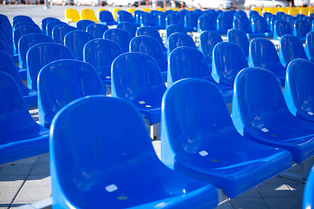 istock Blue and Yellow Plastic Stadium Seats Outdoors 490064197