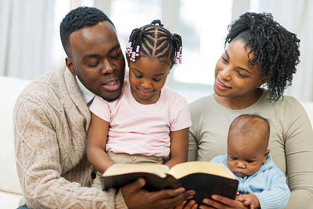 istock Black family bible studying 490064349