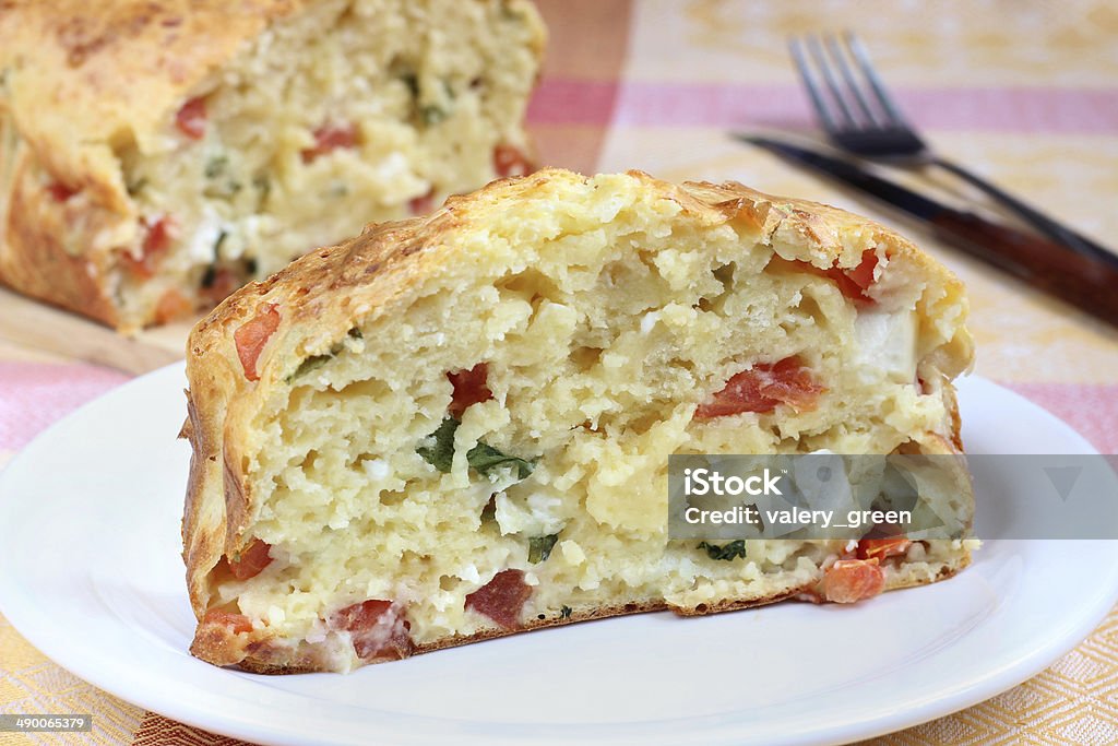 Savory cake with tomato, feta cheese and arugula Feta Cheese Stock Photo