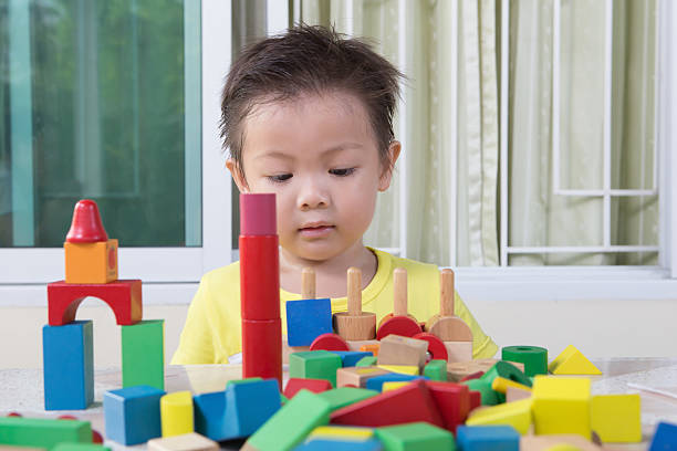 istock three-year child plays with toy blocks 490066917