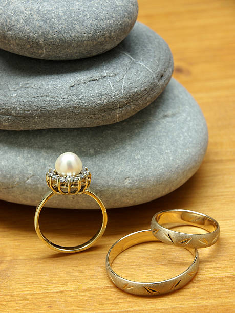 istock Wedding rings and pebble stones 490066965
