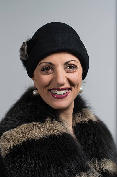 istock smiling woman with dark hat and fur coat 490067705