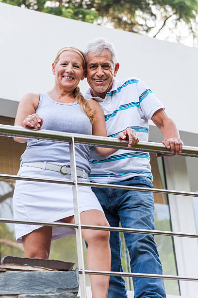 istock senior couple standing on terrace modern house 490068197
