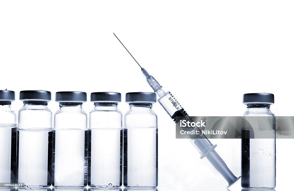 Vials and Syringe Glass Medicine Vials and botox, hualuronic, collagen or flu Syringe on a white background. Botulinum Toxin Injection Stock Photo