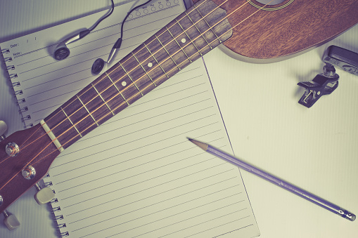 concept song composer:Notebook and pencil ,Ukulele ,style vintage