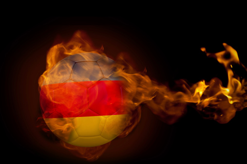 Composite image of fire surrounding germany ball against black