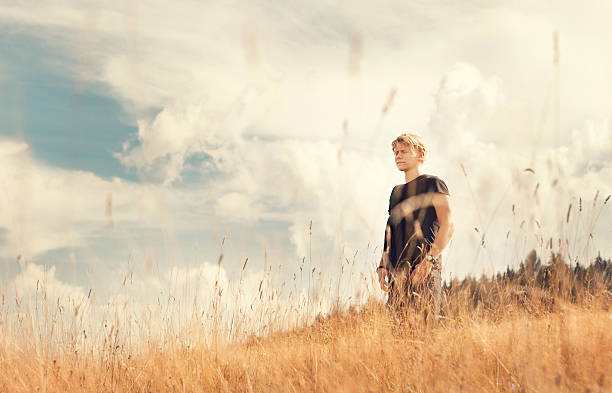 istock Young man enjoy with tender breeze on golden field 490070140