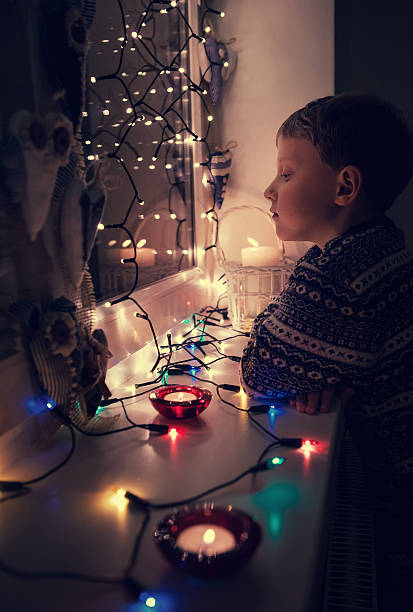 istock Waiting boy portrait in Christmas lights 490070200
