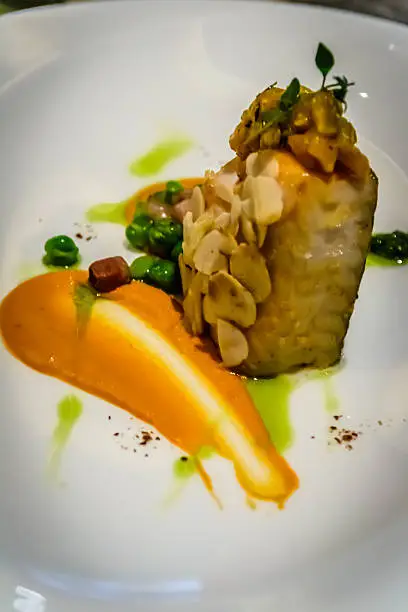 Pan-seared Black Cod with Bell Pepper and Hazelnut Mousse, served with Almonds, Bell Pepper and Green Peas