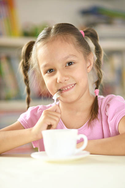 istock Cute little girl with cup 490073740