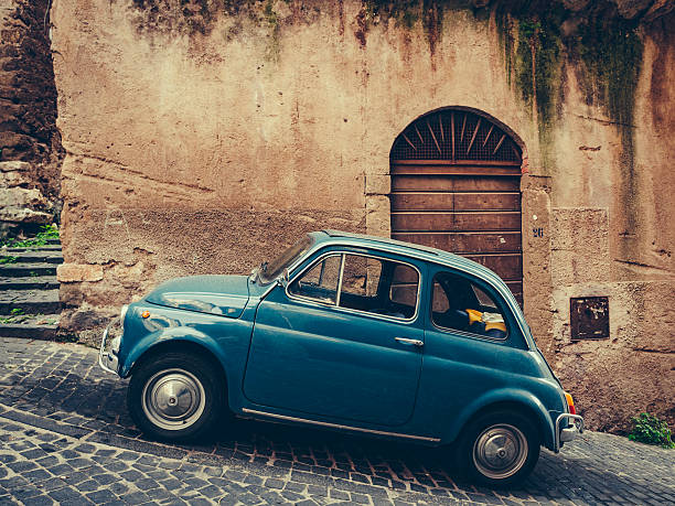 Vintage italian blue car on cobbled street stock photo