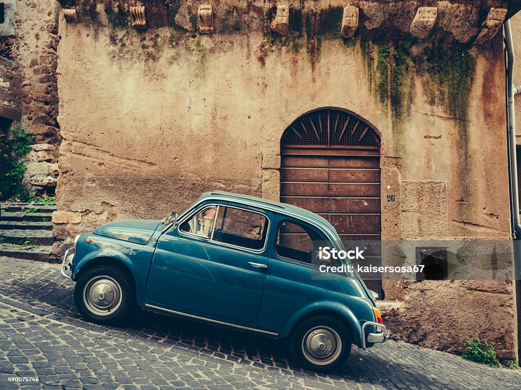 Vintage italian blue car on cobbled street Car Stock Photo