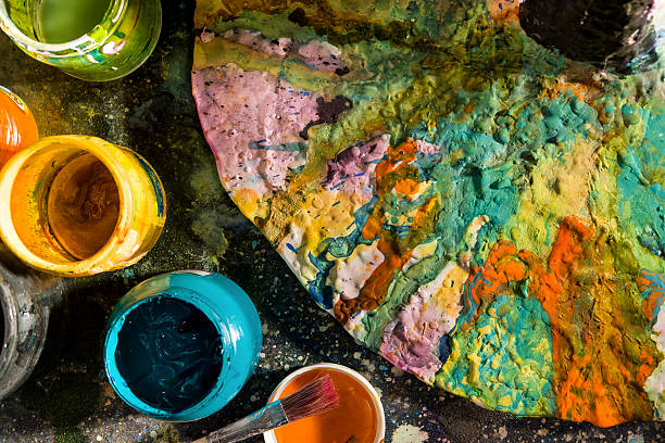 istock Open paint cans next to the color palette 490076422
