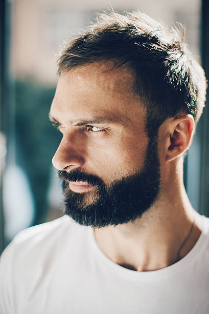 istock Portrait of a bearded man looking out the window 490078282