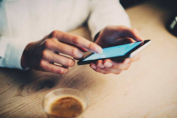 istock Closeup of girl using her smartphone and take a coffe 490079468