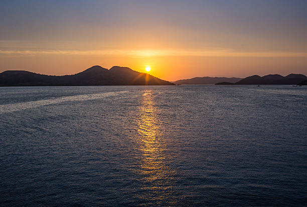 istock Wonderful sunset over the ocean, where sailing boat 490082606