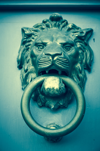 Lion's head door knocker, artistic toned photo