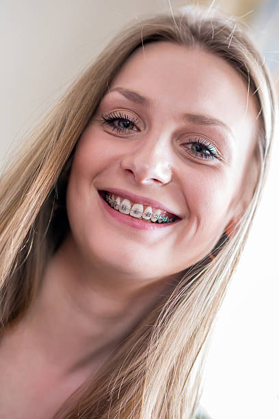 istock Smiling young woman with braces 490097398