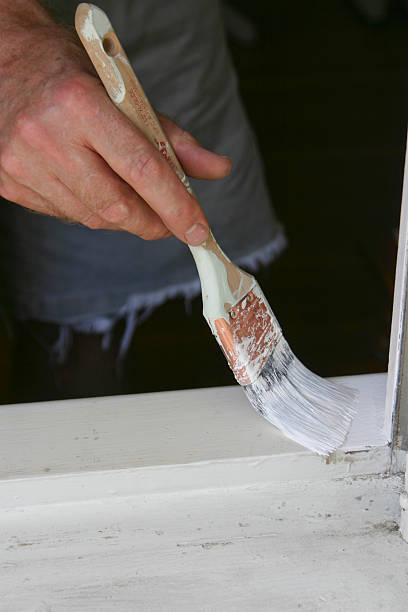 istock Man Painting a Window Sill 490097692