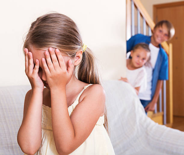 istock smiling children hiding from girl 490098020